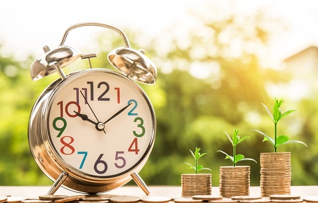 growing pile of coins over time, with a clock