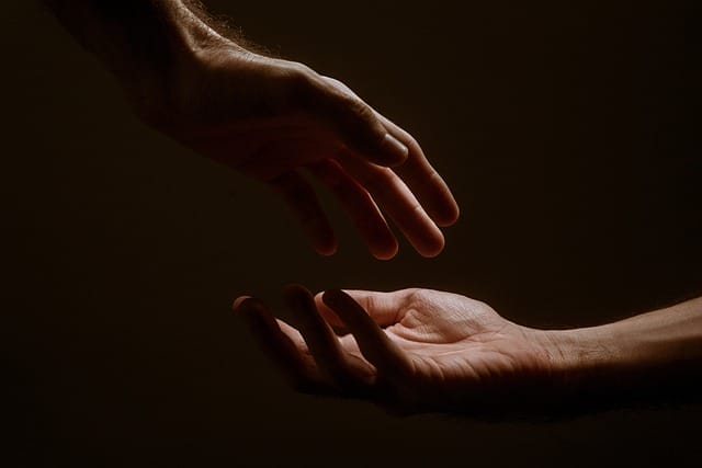 Two hands reaching out to each other